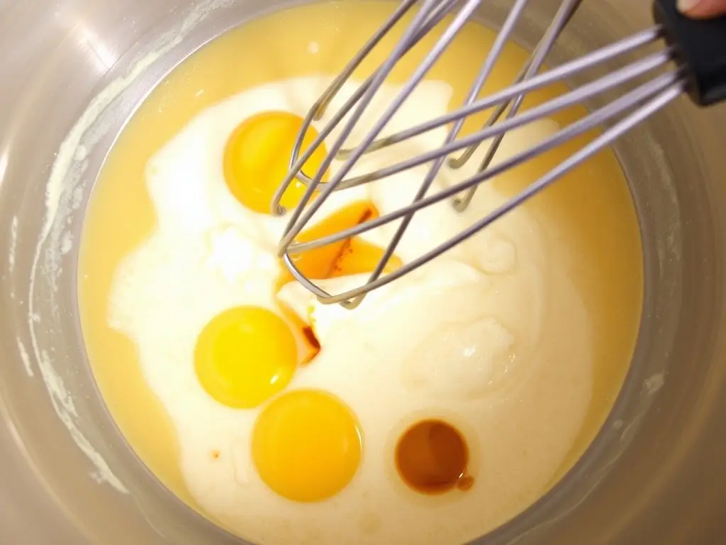 Whisking sourdough starter, oil, and vanilla to create a smooth base for muffins