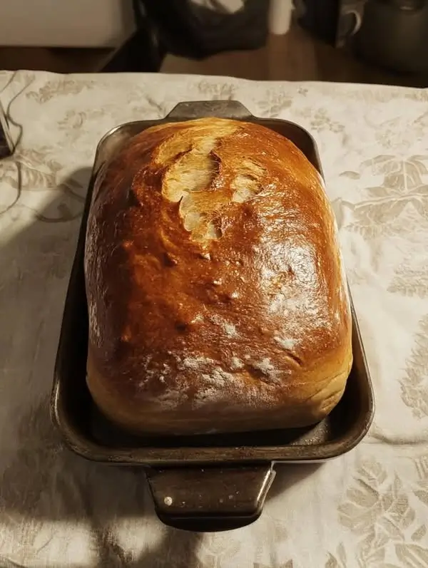 Sourdough starter bread cooling and ready to be sliced, showing a soft, airy crumb structure